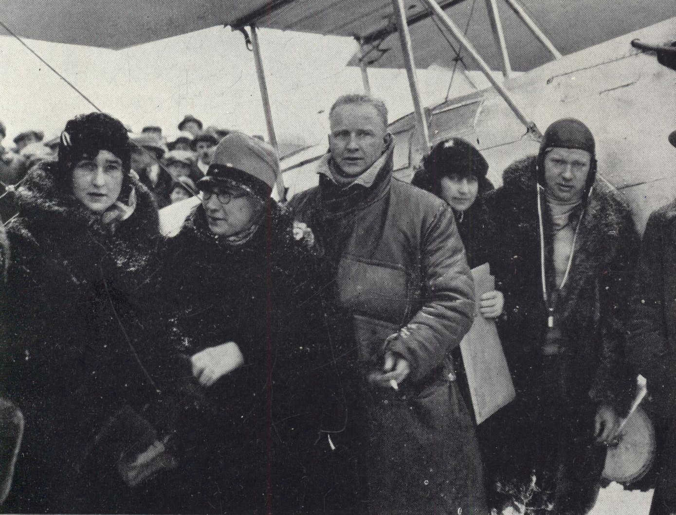 Group of people standing in front of airplane
