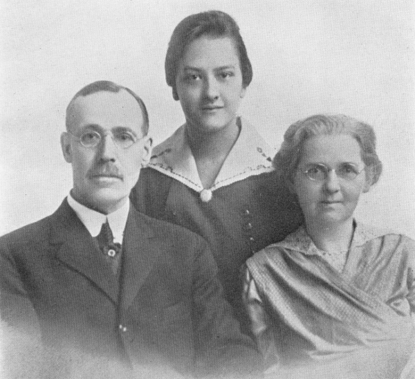 Photo of Dodd and wife sitting with daughter standing behind