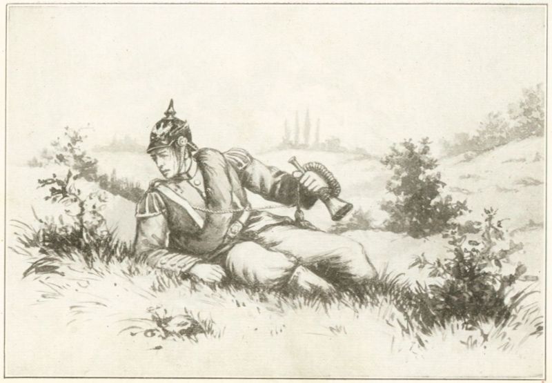 a soldier laying on the ground and holding a bugle.