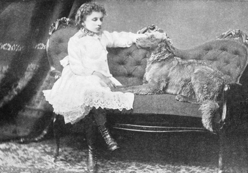 Helen sitting on a couch with her dog