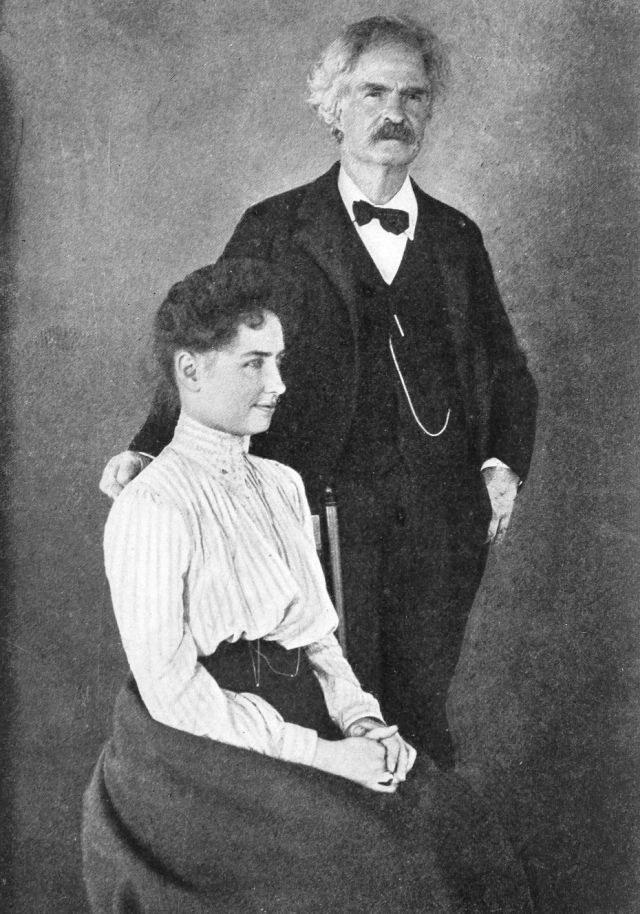 Helen sitting in a chair with Mark Twain standing next to her